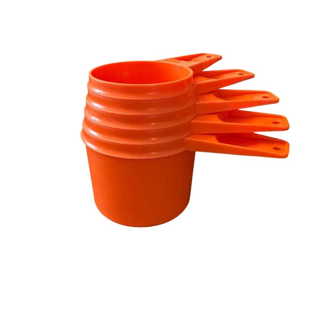 Vintage orange Tupperware measuring cup set.  5 cups missing the 1/4 cup.  EUC